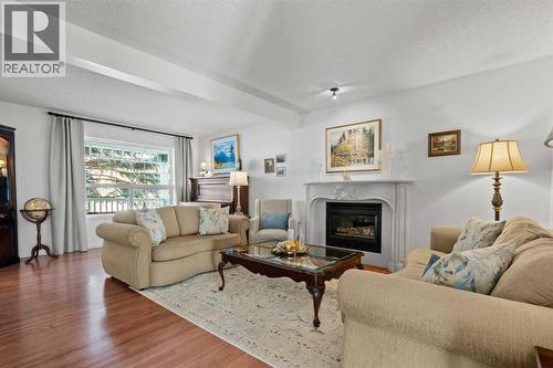 63 Springbank Crescent Sw, Calgary, AB - Indoor Photo Showing Living Room With Fireplace