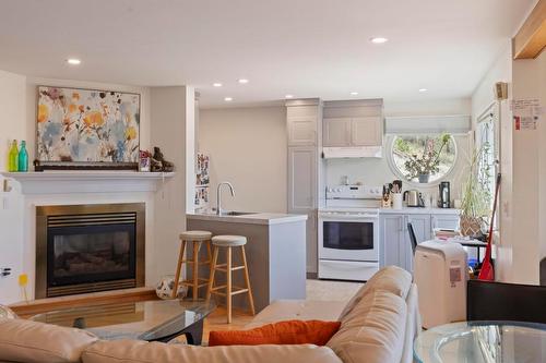 2266 Omineca Place, Kelowna, BC - Indoor Photo Showing Living Room With Fireplace