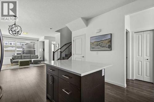 View of the dining space and the main level from the kitchen - 59 Wolf Hollow Way Se, Calgary, AB - Indoor