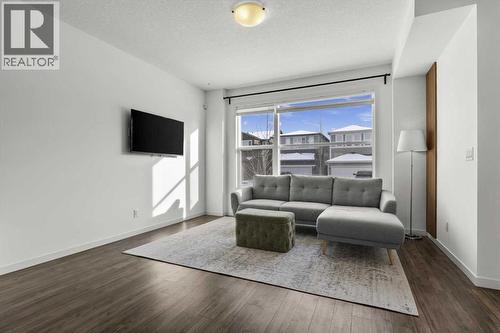 Unwind at the end of the day with family and friends.. - 59 Wolf Hollow Way Se, Calgary, AB - Indoor Photo Showing Living Room