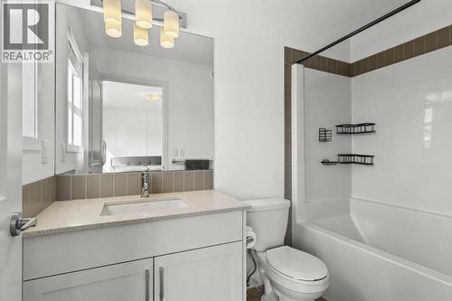 The 4-piece ensuite carries a consistent design influence, combining form and function with understated elegance - 59 Wolf Hollow Way Se, Calgary, AB - Indoor Photo Showing Bathroom