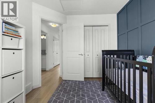 A bright and functional layout offers easy access to the closet and nearby bathroom - 59 Wolf Hollow Way Se, Calgary, AB - Indoor Photo Showing Bedroom