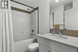 The shared upper-level bathroom features a clean, functional design with neutral finishes and a full tub-shower combination - 