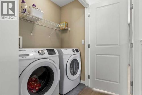 A conveniently located upper-level laundry enhances day-to-day functionality - 59 Wolf Hollow Way Se, Calgary, AB - Indoor Photo Showing Laundry Room