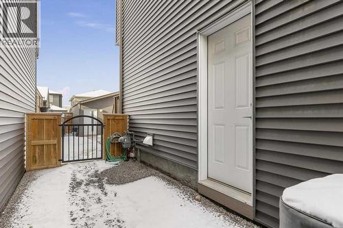 The side entrance creates a practical transition to the lower level, adding functional flexibility to the home - 59 Wolf Hollow Way Se, Calgary, AB - Outdoor With Exterior