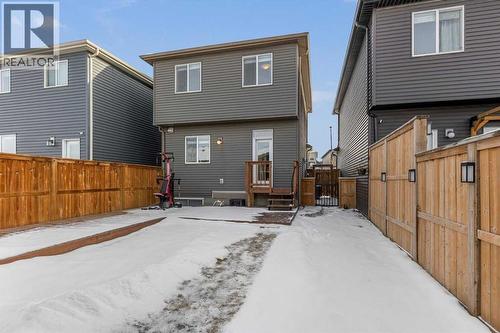 The rear yard provides convenient access to the detached garage and functional outdoor storage - 59 Wolf Hollow Way Se, Calgary, AB - Outdoor With Exterior