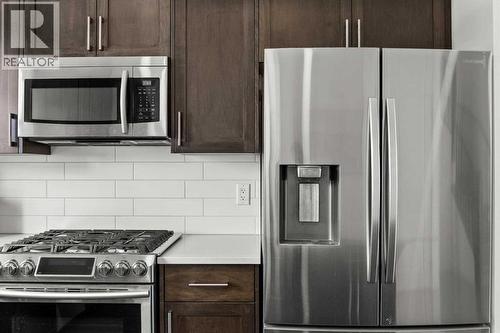 The premium stainless steel appliances highlight this kitchen package.. - 59 Wolf Hollow Way Se, Calgary, AB - Indoor Photo Showing Kitchen With Stainless Steel Kitchen With Upgraded Kitchen