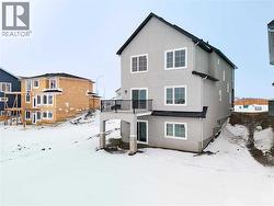 Back of the home with a walk out basement out onto the canal - 