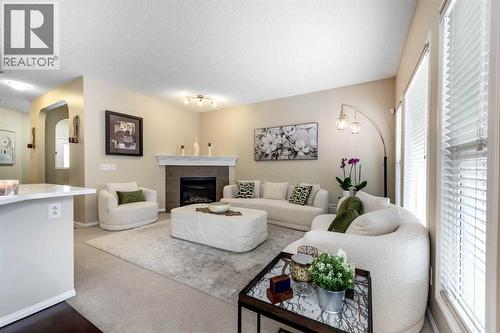 212 Silverado Range Heights Sw, Calgary, AB - Indoor Photo Showing Living Room With Fireplace