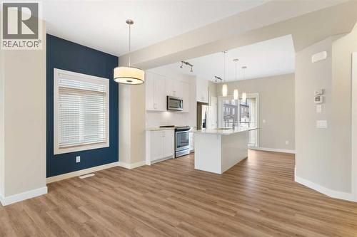 Dining room and kitchen - 217 Sage Bluff Drive Nw, Calgary, AB - Indoor Photo Showing Kitchen With Upgraded Kitchen