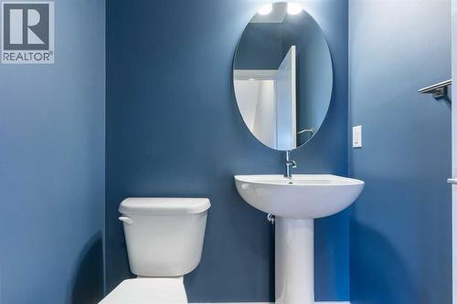 2-piece powder room, ceramic tile floor - 217 Sage Bluff Drive Nw, Calgary, AB - Indoor Photo Showing Bathroom