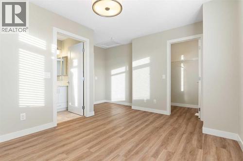 Front primary bedroom, 3-piece en-suite bathroom with walk-in shower and ceramic tile floor - 217 Sage Bluff Drive Nw, Calgary, AB - Indoor Photo Showing Other Room