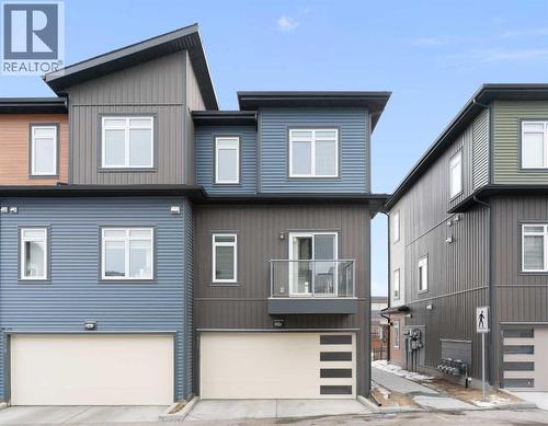 Rear view, end unit, double attached garage, door opener., rear balcony - 217 Sage Bluff Drive Nw, Calgary, AB - Outdoor