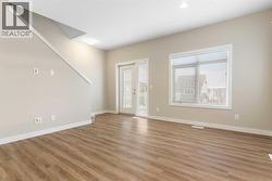 Living room, stairs to upper level, door to balcony - 