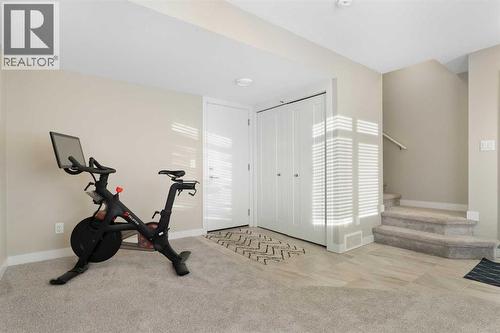 Flex room, entrance to garage, utility room - 217 Sage Bluff Drive Nw, Calgary, AB - Indoor Photo Showing Gym Room