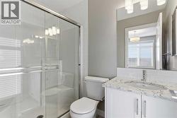 Front primary bedroom 3-piece en-suite bathroom, walk-in shower, comfort height elongated toilet, quartz counter, tile floor - 