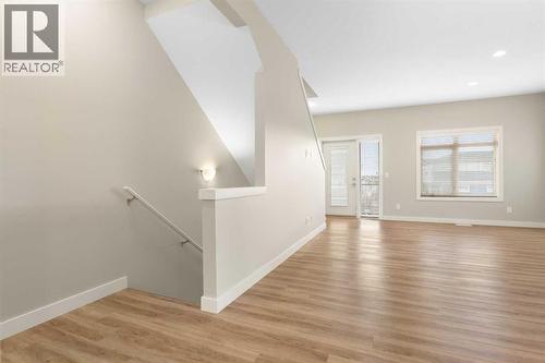 Main level, living room, luxury vinyl plank flooring. 9' knock down ceiling, - 217 Sage Bluff Drive Nw, Calgary, AB - Indoor Photo Showing Other Room