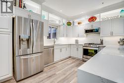 Beautifully Updated Kitchen With Generous Island Seating, Modern Finishes, And A Bright Open Feel - 