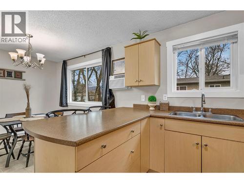 New trim and resealed around windows - 588 Mccurdy Road, Kelowna, BC - Indoor Photo Showing Kitchen With Double Sink