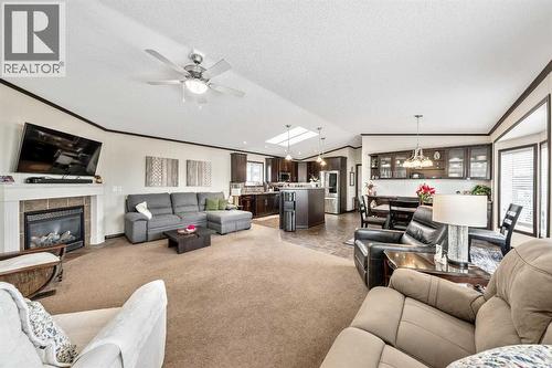 Come On In! - 4 Spring Dale Circle Se, Airdrie, AB - Indoor Photo Showing Living Room With Fireplace