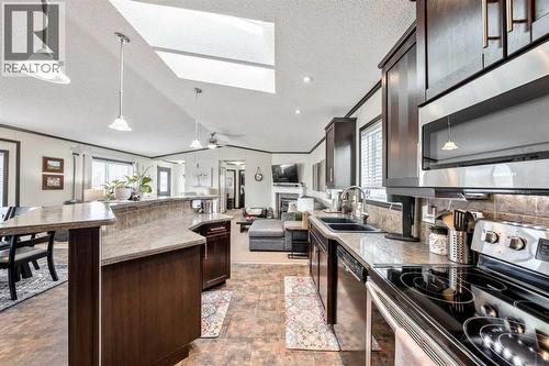 UPDATED Kitchen w/ STAINLESS STEEL Appliances & Rich Extended Height Cabinetry - 4 Spring Dale Circle Se, Airdrie, AB - Indoor Photo Showing Kitchen With Double Sink