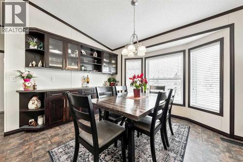 Beautiful Dining Area w/ Rich Cabinetry - 4 Spring Dale Circle Se, Airdrie, AB - Indoor Photo Showing Dining Room