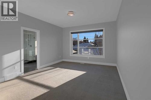 Primary bedroom with walk in closet and 5 piece ensuite - 2319 23 Avenue Sw, Calgary, AB - Indoor Photo Showing Other Room
