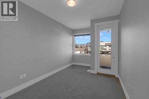Bedroom 2 with balcony - 2319 23 Avenue Sw, Calgary, AB - Indoor Photo Showing Other Room