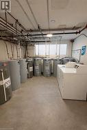 Below grade area with electric water heater and independent washer and dryer - 