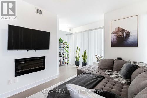 2221 - 30 Shore Breeze Drive, Toronto, ON - Indoor Photo Showing Living Room With Fireplace