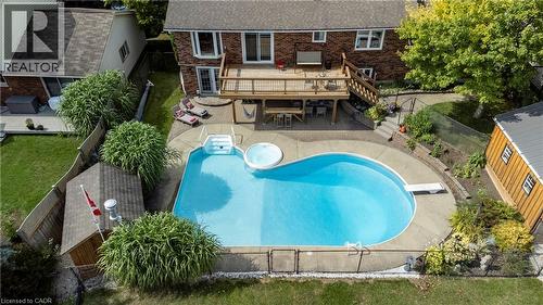 Rear view of house with a fenced backyard, a deck, a patio area, brick siding, and outdoor dining area - 29 Armstrong Crescent, Grey Highlands, ON - Outdoor With In Ground Pool With Deck Patio Veranda