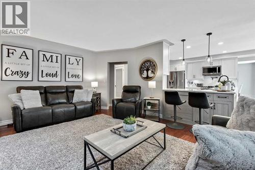 LR into Kitchen - 7 Mountain Park Circle Se, Calgary, AB - Indoor Photo Showing Living Room