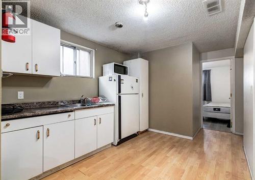 7634 & 7636 22A Street Se, Calgary, AB - Indoor Photo Showing Kitchen With Double Sink