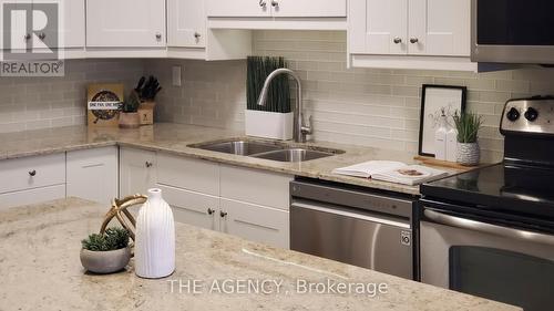 119 - 60 Southport Street N, Toronto, ON - Indoor Photo Showing Kitchen With Double Sink