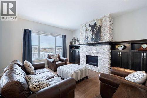 155 Crestridge Hill Sw, Calgary, AB - Indoor Photo Showing Living Room With Fireplace
