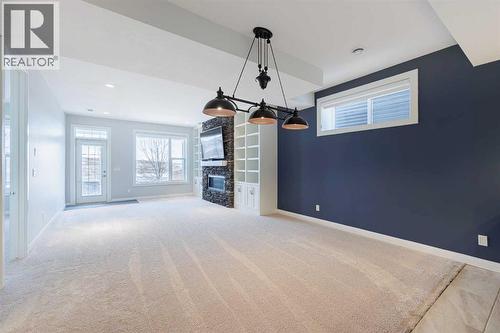 155 Crestridge Hill Sw, Calgary, AB - Indoor Photo Showing Other Room With Fireplace