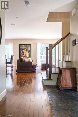Living area featuring healthy amount of natural light, wood-type flooring, stairway, and baseboards - 330 Strathcona Drive, Burlington, ON - Indoor