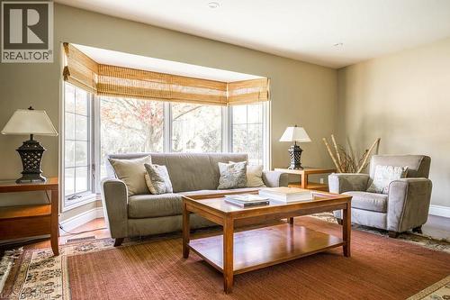 Living area featuring healthy amount of natural light, wood finished floors, and baseboards - 330 Strathcona Drive, Burlington, ON - Indoor Photo Showing Living Room