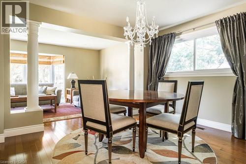 Dining area featuring ornate columns, hardwood / wood-style flooring, baseboards, and a chandelier - 330 Strathcona Drive, Burlington, ON - Indoor Photo Showing Dining Room