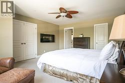 Carpeted bedroom featuring ceiling fan, baseboards, recessed lighting, and a closet - 