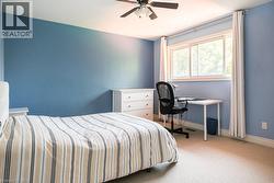 Bedroom with carpet floors, baseboards, and a ceiling fan - 