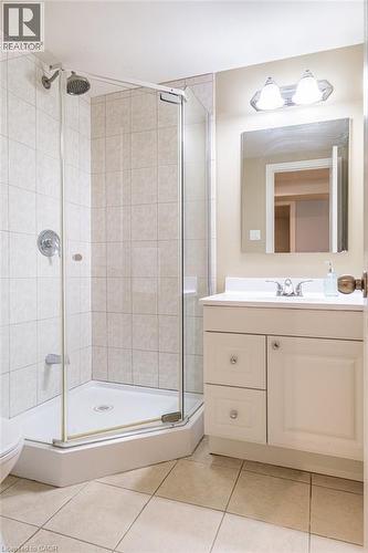 Bathroom featuring a shower stall, tile patterned floors, vanity, and toilet - 330 Strathcona Drive, Burlington, ON - Indoor Photo Showing Bathroom