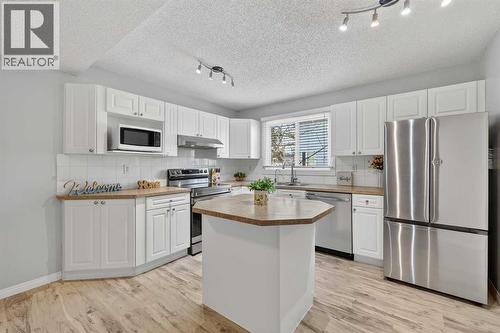 115, 4810 40 Avenue Sw, Calgary, AB - Indoor Photo Showing Kitchen With Stainless Steel Kitchen