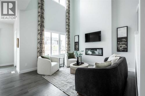 21 Sora Gardens Se, Calgary, AB - Indoor Photo Showing Living Room With Fireplace