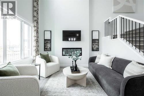 21 Sora Gardens Se, Calgary, AB - Indoor Photo Showing Living Room With Fireplace