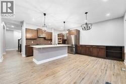Gorgeous chef’s kitchen with ample counter space, a walk-through pantry, and high-end stainless steel appliances. - 