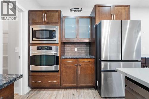 Chef-inspired kitchen with built-in oven and quality stainless steel appliances. - 70 Royal Ridge Manor Nw, Calgary, AB - Indoor Photo Showing Kitchen With Upgraded Kitchen