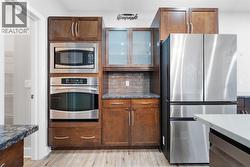 Chef-inspired kitchen with built-in oven and quality stainless steel appliances. - 