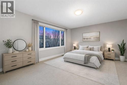The primary bedroom offers ample space and a 5-piece ensuite (Virtually Staged). - 70 Royal Ridge Manor Nw, Calgary, AB - Indoor Photo Showing Bedroom