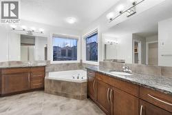 Spacious 5-piece ensuite featuring a standing shower. - 